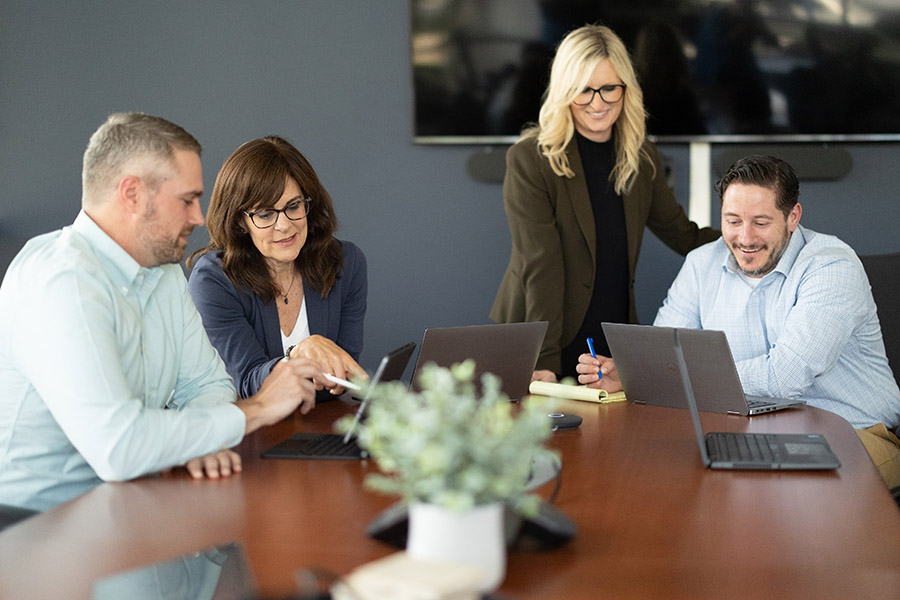 Holmes Corporation HC team working on laptops in conference room